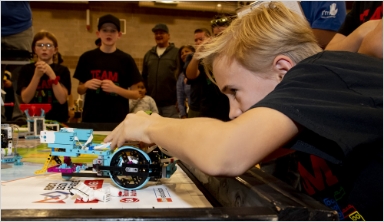 A young kid works on a LEGO project.