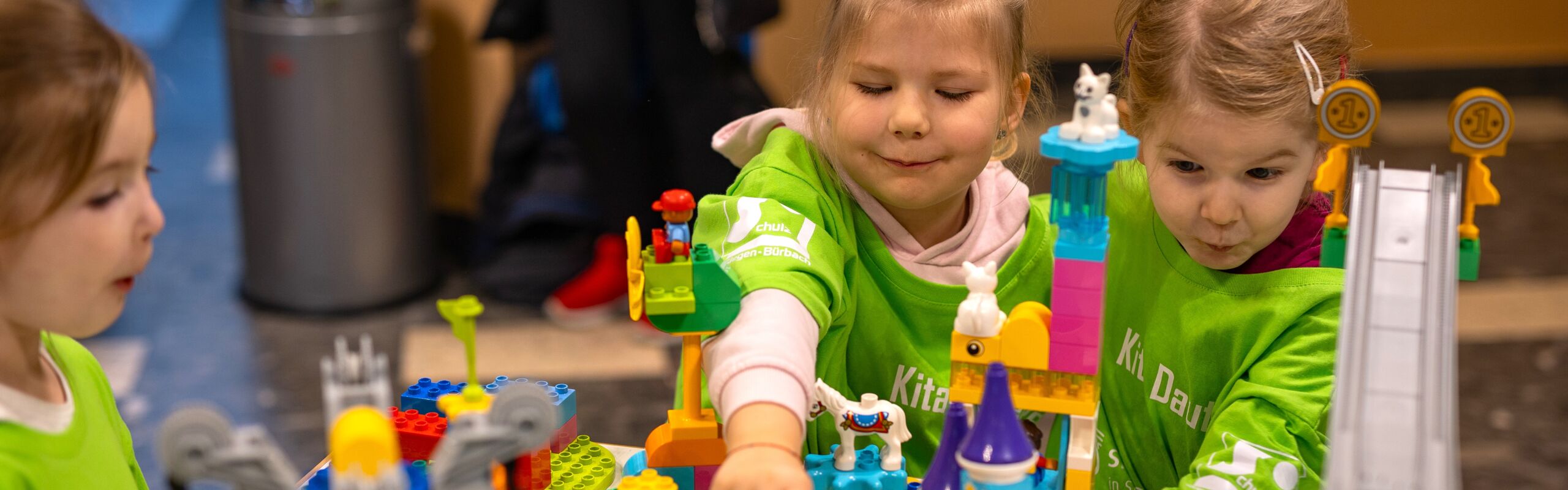 A group of kids smiles as they participate in FIRST Discover.